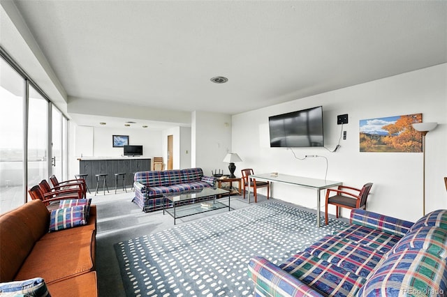 carpeted living room featuring bar