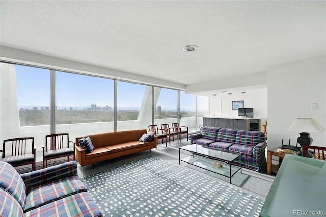 living room with a textured ceiling, a water view, and carpet