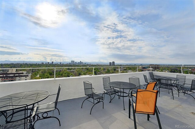 view of patio featuring a city view and outdoor dining area