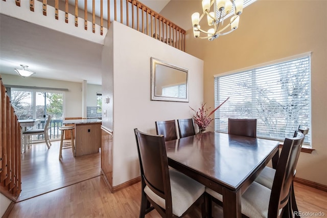 dining area featuring light hardwood / wood-style floors and an inviting chandelier