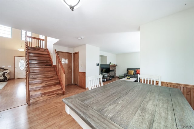 dining space featuring wood walls and light hardwood / wood-style floors