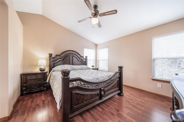 bedroom featuring dark hardwood / wood-style flooring, vaulted ceiling, and ceiling fan