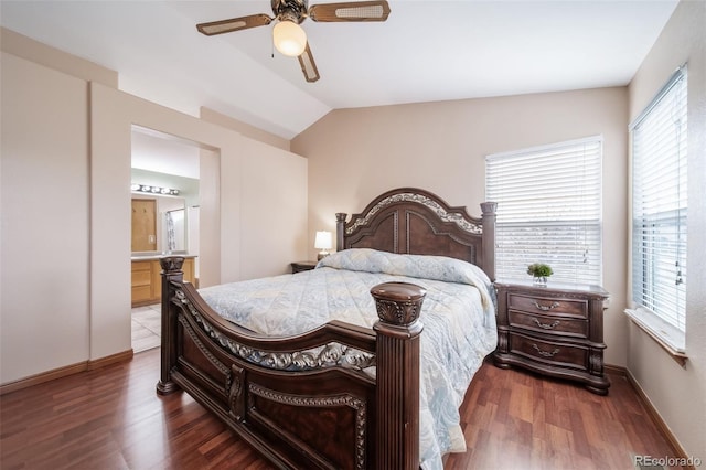 bedroom featuring dark wood-type flooring, ensuite bath, ceiling fan, and lofted ceiling