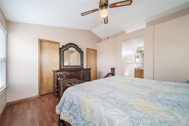 bedroom with ceiling fan, vaulted ceiling, wood-type flooring, and ensuite bath