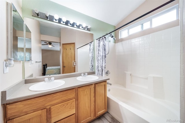 bathroom featuring ceiling fan, vaulted ceiling, vanity, and shower / tub combo with curtain