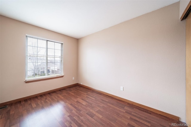 empty room featuring dark hardwood / wood-style floors