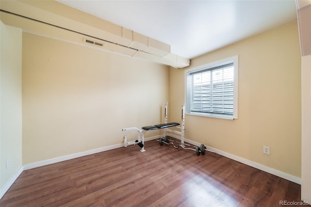 unfurnished room with wood-type flooring