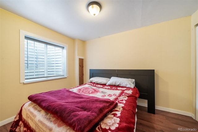 bedroom featuring dark hardwood / wood-style flooring