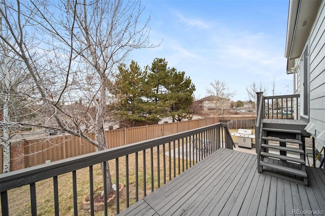 wooden terrace with a lawn