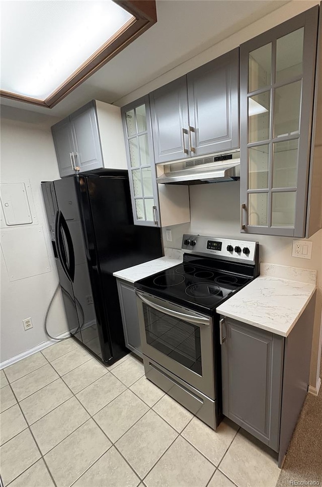 kitchen with electric stove, gray cabinets, and under cabinet range hood