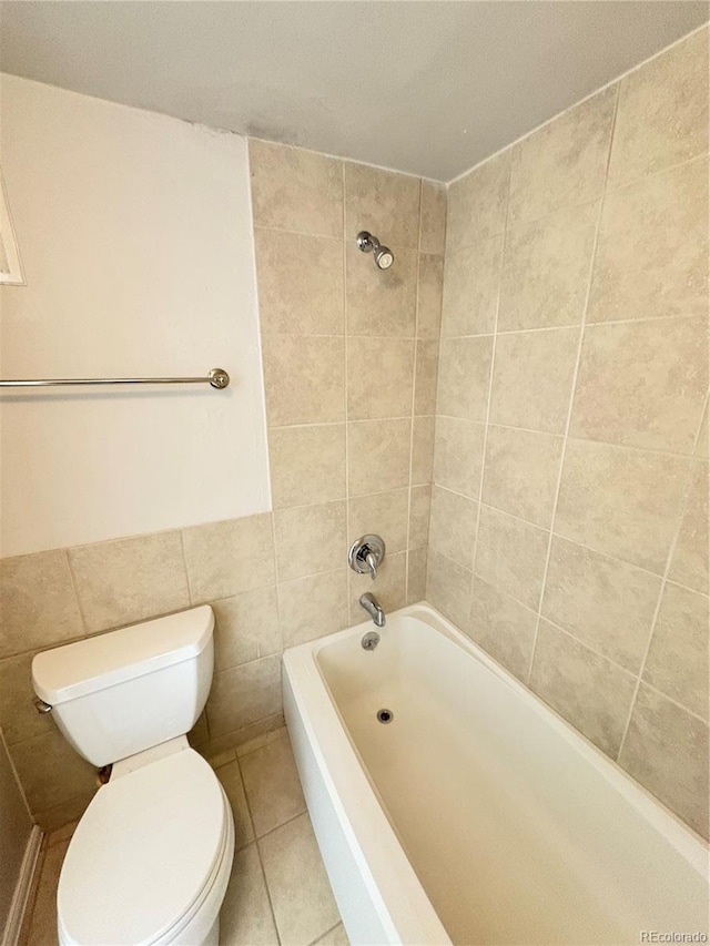 bathroom featuring tile walls, bathtub / shower combination, toilet, and tile patterned floors