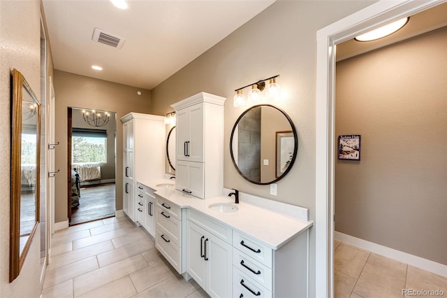 31455 Half Peak Trl, Pine, CO 80470 - bathroom featuring connected bathroom, tile patterned floors, double vanity, a chandelier, and baseboards