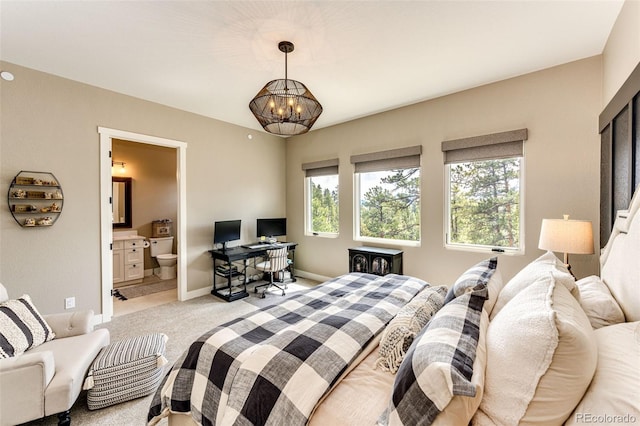 31455 Half Peak Trl, Pine, CO 80470 - bedroom with light carpet, a chandelier, a desk, ensuite bathroom, and baseboards