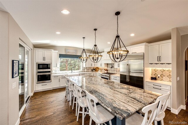 31455 Half Peak Trl, Pine, CO 80470 - kitchen featuring built in appliances, a chandelier, white cabinetry, tasteful backsplash, and recessed lighting