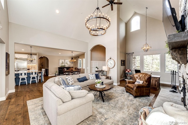 31455 Half Peak Trl, Pine, CO 80470 - living area with a chandelier, high vaulted ceiling, arched walkways, hardwood / wood-style flooring, and baseboards