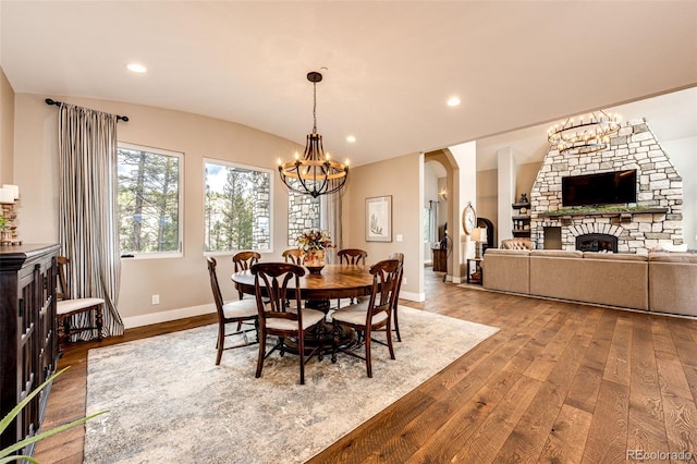 31455 Half Peak Trl, Pine, CO 80470 - dining room featuring a chandelier, hardwood / wood-style floors, baseboards, arched walkways, and recessed lighting