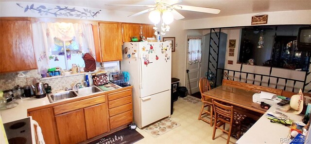 8338 Charles Way, Denver, CO 80221 - kitchen with freestanding refrigerator, light floors, ceiling fan, a sink, and brown cabinetry