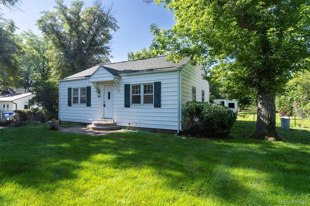 5680 W 41st Ave, Wheat Ridge, CO 80212 - bungalow with a front yard and roof with shingles