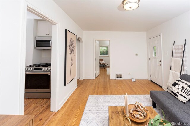 5680 W 41st Ave, Wheat Ridge, CO 80212 - living room with light wood-style flooring and arched walkways