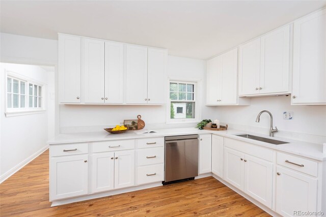 5680 W 41st Ave, Wheat Ridge, CO 80212 - kitchen featuring stainless steel dishwasher, white cabinets, light countertops, and light wood-style floors