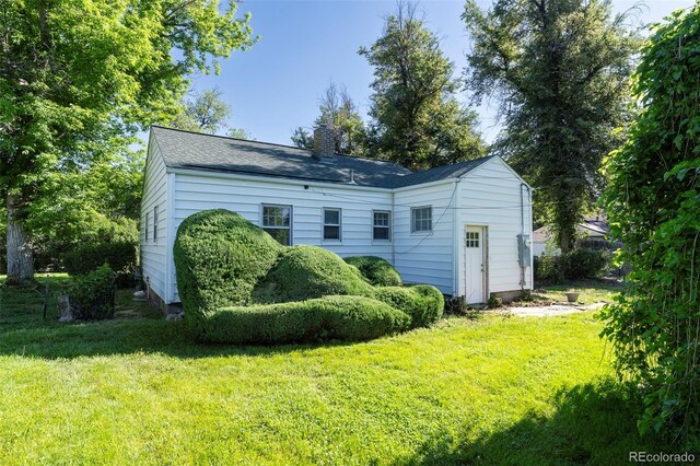 5680 W 41st Ave, Wheat Ridge, CO 80212 - rear view of property featuring a yard and a chimney