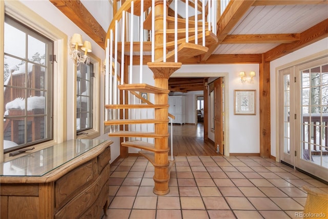 entrance foyer featuring light tile patterned floors, stairs, baseboards, and beam ceiling