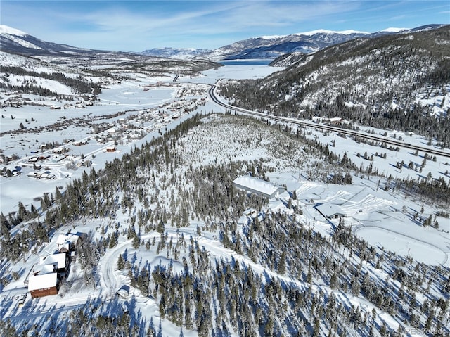 snowy aerial view featuring a mountain view