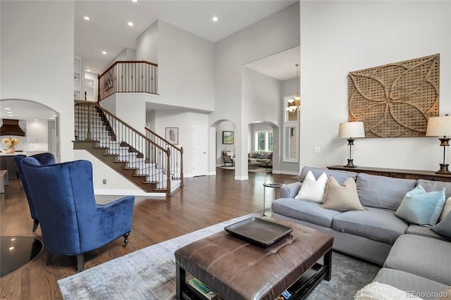 9669 E Prentice Cir, Greenwood Village, CO 80111 - living room featuring arched walkways, wood finished floors, stairway, a high ceiling, and recessed lighting