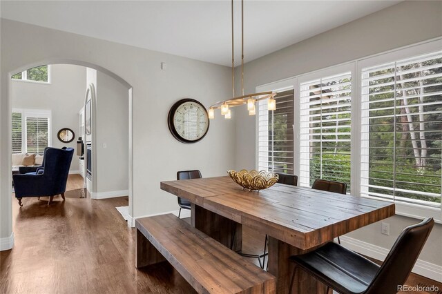 9669 E Prentice Cir, Greenwood Village, CO 80111 - dining room with arched walkways, baseboards, and wood finished floors