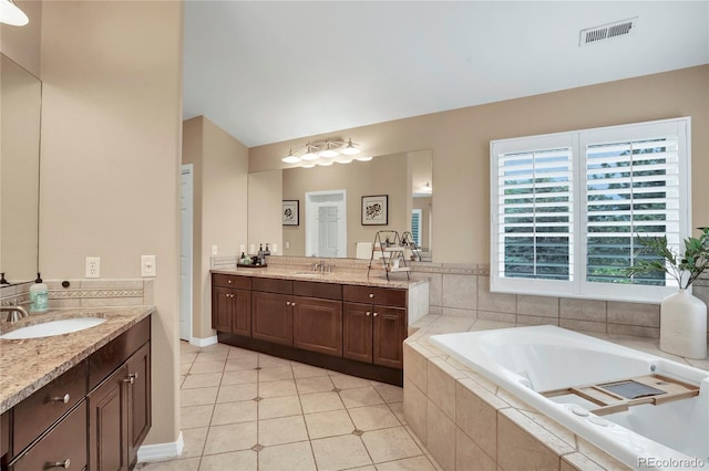 9669 E Prentice Cir, Greenwood Village, CO 80111 - bathroom featuring two vanities, a garden tub, and tile patterned flooring