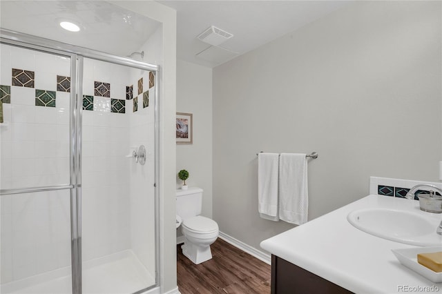 9669 E Prentice Cir, Greenwood Village, CO 80111 - bathroom featuring vanity, a stall shower, toilet, and wood finished floors
