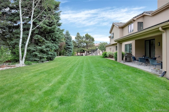 9669 E Prentice Cir, Greenwood Village, CO 80111 - view of green lawn featuring a patio