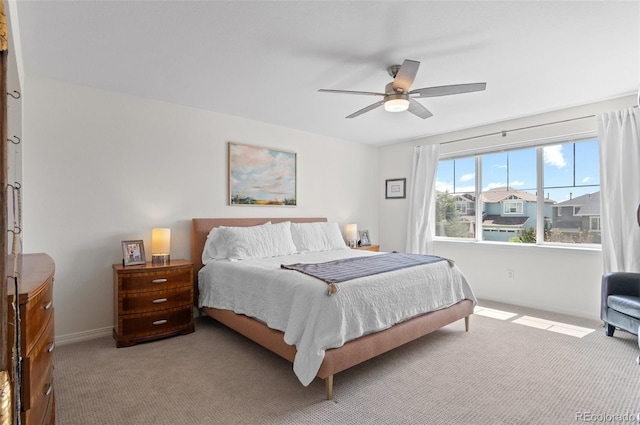 carpeted bedroom with baseboards and ceiling fan