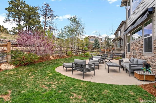 view of yard with an outdoor living space, a fenced backyard, and a patio