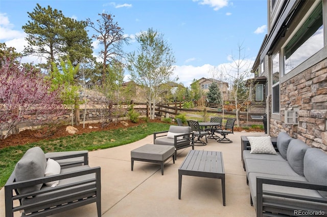 view of patio featuring outdoor dining area, a fenced backyard, and an outdoor hangout area