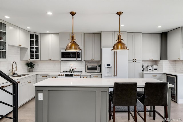 kitchen with decorative backsplash, a kitchen island, stainless steel appliances, and a breakfast bar area