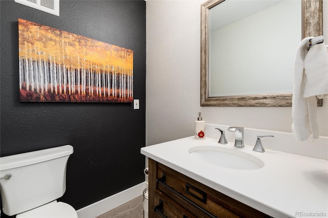 bathroom featuring vanity and toilet