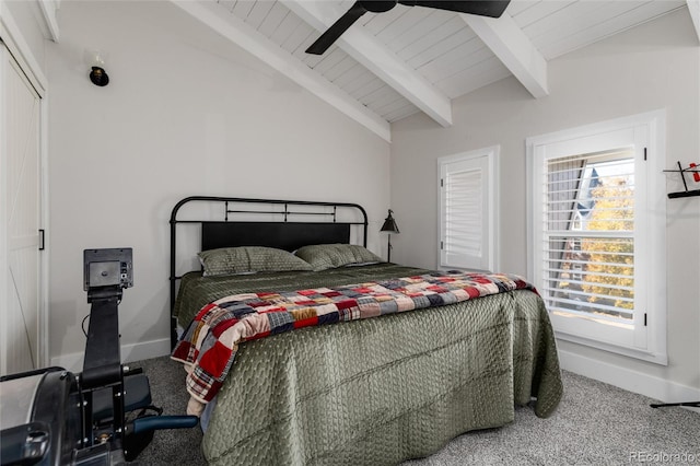 carpeted bedroom featuring wood ceiling, ceiling fan, a closet, and lofted ceiling with beams