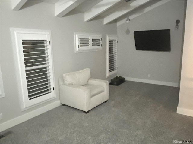 sitting room featuring carpet and lofted ceiling with beams