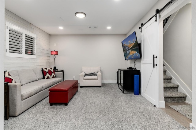 living room with carpet and a barn door