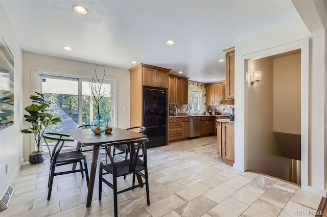 kitchen with dishwasher, built in fridge, and backsplash