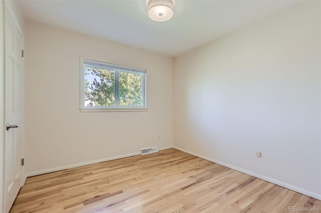 spare room featuring light hardwood / wood-style floors