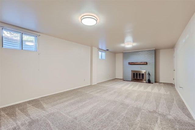 basement featuring light carpet and a fireplace