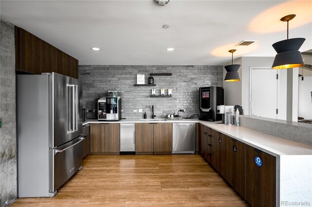 1700 Bassett St Unit 1119, Denver, CO 80202 - kitchen featuring stainless steel appliances, a sink, light countertops, light wood finished floors, and recessed lighting