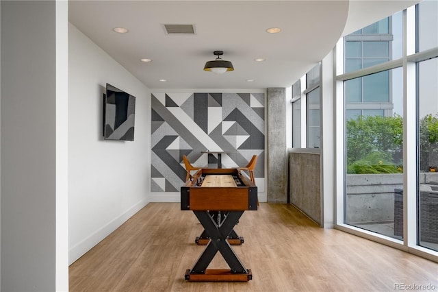 1700 Bassett St Unit 1119, Denver, CO 80202 - home office featuring recessed lighting, wood finished floors, baseboards, floor to ceiling windows, and an accent wall