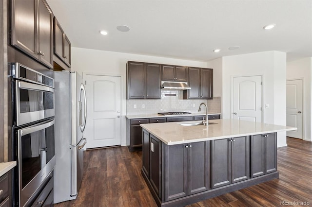 6214 Long Branch Dr, Parker, CO 80134 - kitchen with dark brown cabinets, a sink, stainless steel appliances, dark wood-type flooring, and under cabinet range hood