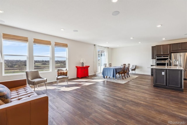6214 Long Branch Dr, Parker, CO 80134 - living area featuring baseboards, dark wood-style flooring, and recessed lighting