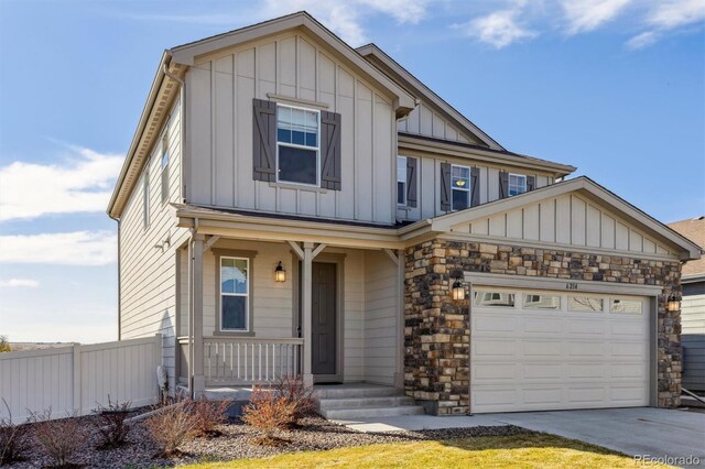 6214 Long Branch Dr, Parker, CO 80134 - view of front of house with covered porch, stone siding, fence, concrete driveway, and board and batten siding