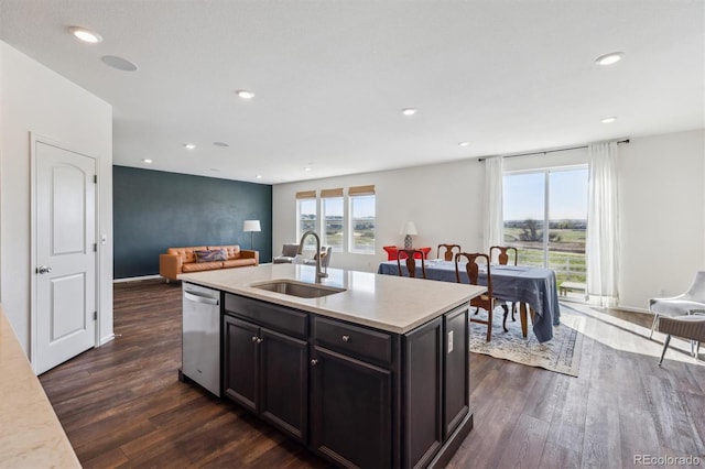 6214 Long Branch Dr, Parker, CO 80134 - kitchen featuring a sink, open floor plan, dark wood finished floors, stainless steel dishwasher, and light countertops