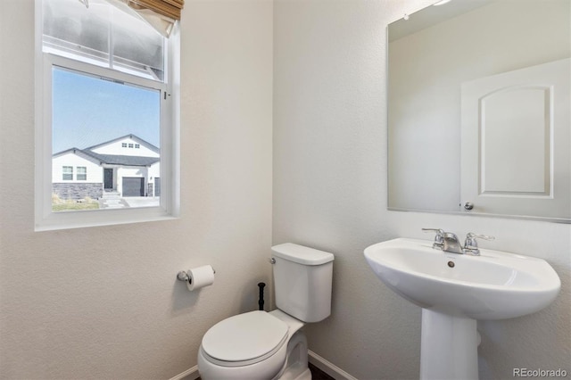 6214 Long Branch Dr, Parker, CO 80134 - half bath with toilet, baseboards, and a sink